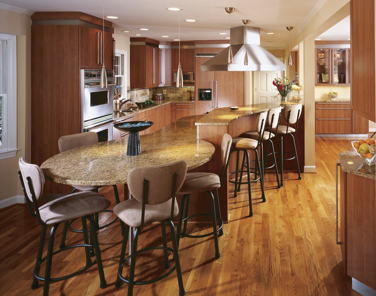 This kitchen, designed by CSI Kitchen & Bath, cabinetry, countertop, dining room, floor, flooring, hardwood, interior design, kitchen, laminate flooring, room, wood, wood flooring, brown