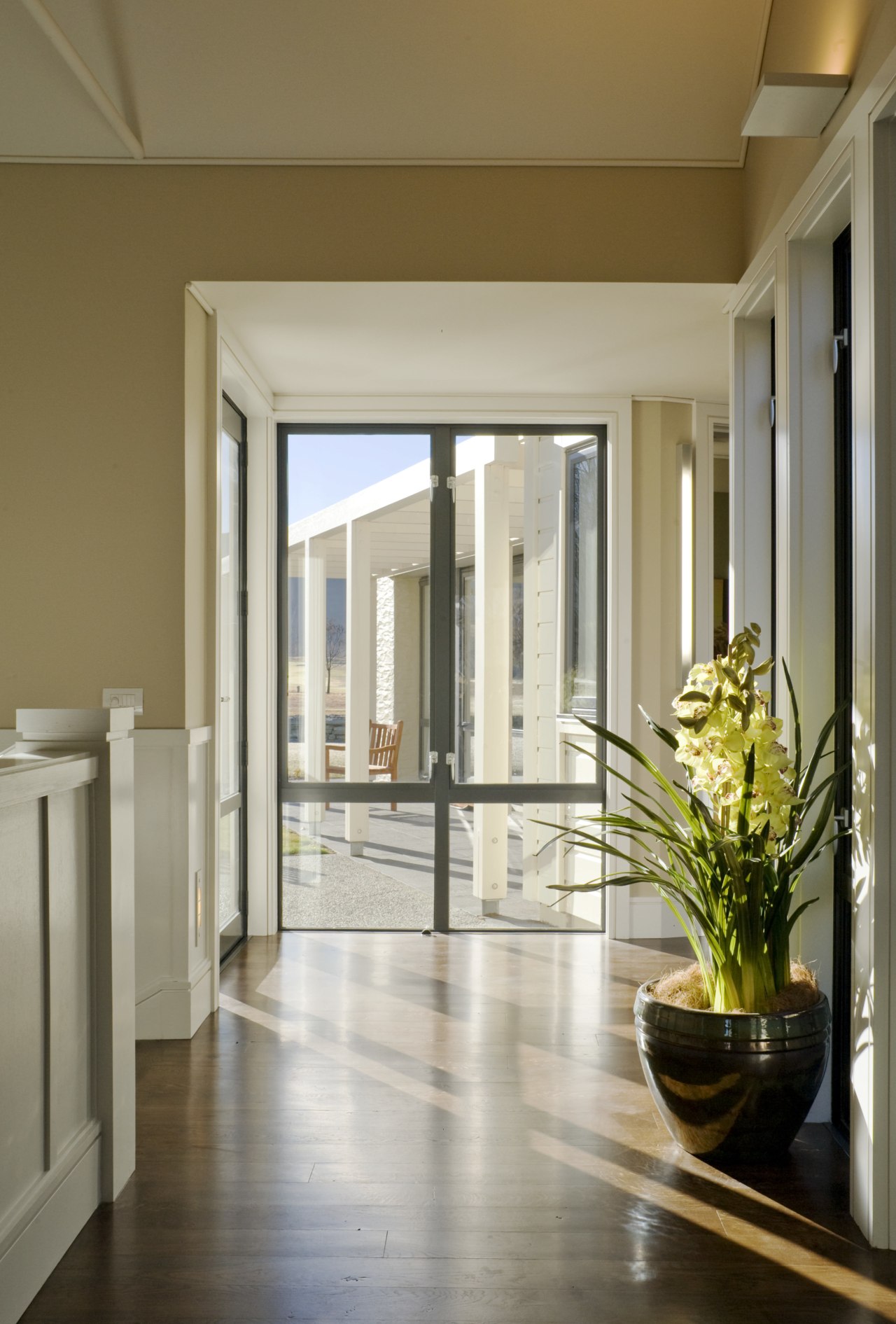 image of the hallway which features wooden flooring, architecture, ceiling, daylighting, door, estate, floor, flooring, hardwood, home, house, interior design, lobby, property, real estate, window, wood flooring, brown, gray