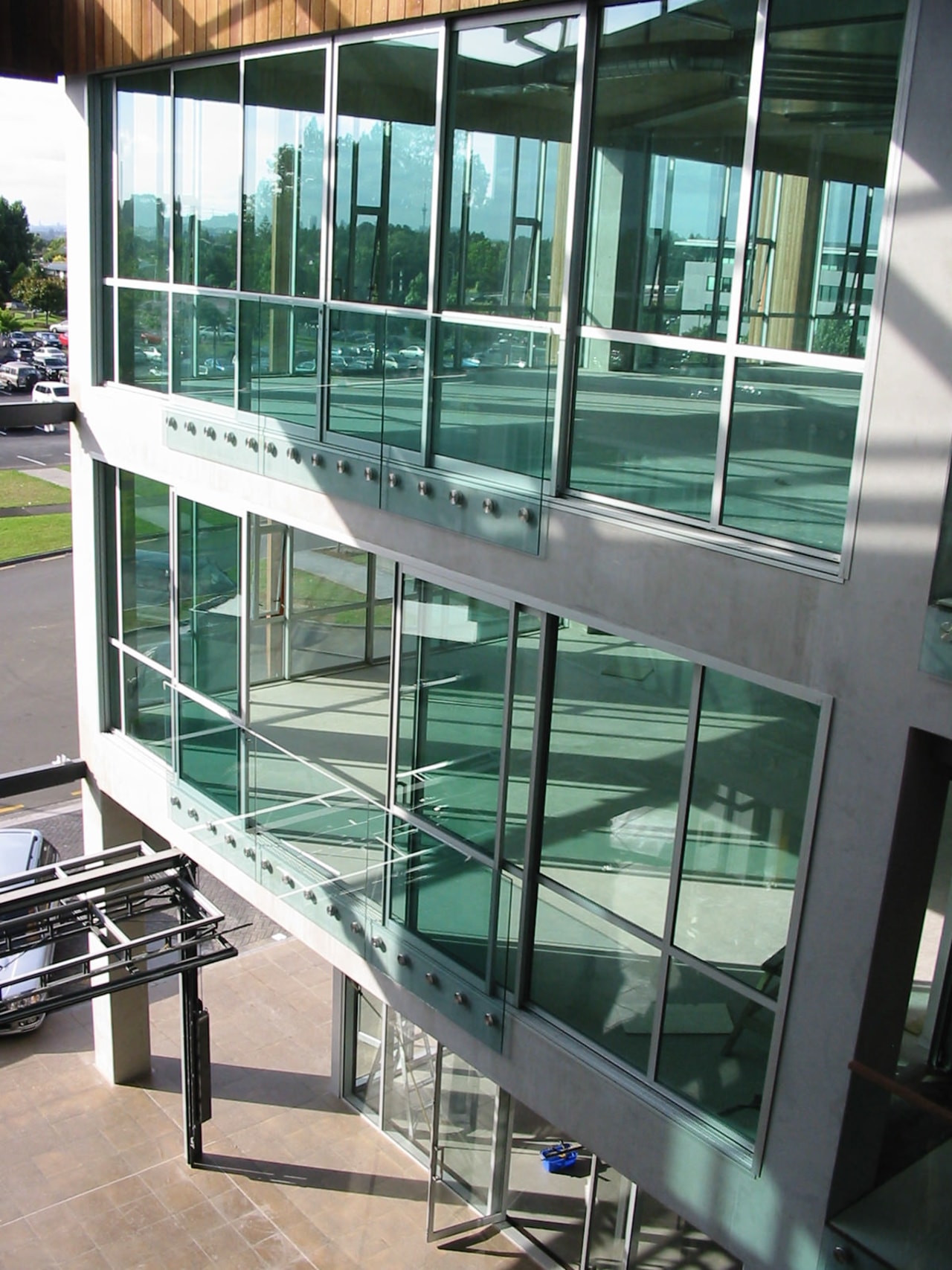 The Q4 building at smales Fram, North Shore, architecture, condominium, daylighting, glass, handrail, window, gray, black