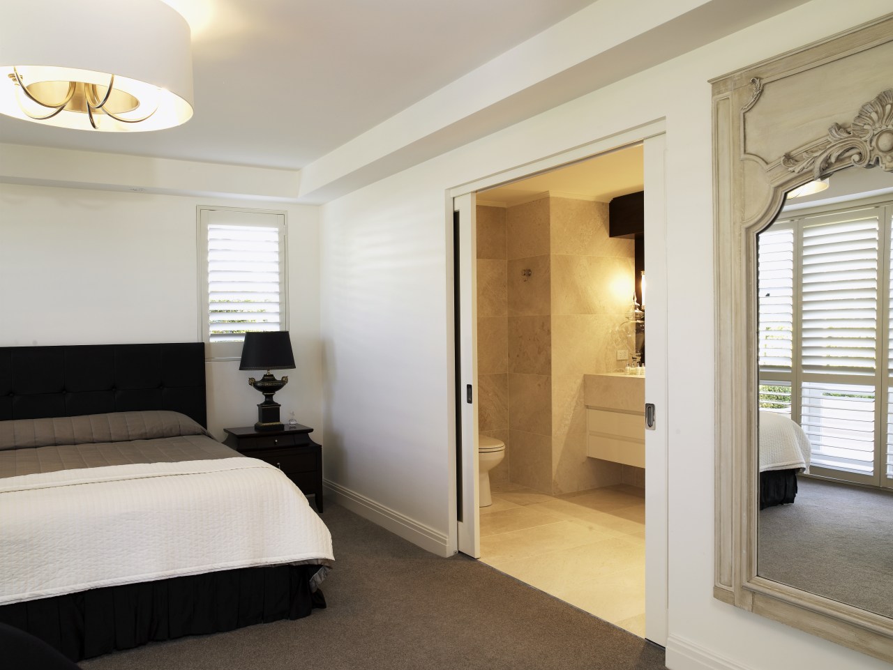 view of master bedroom which features bedroom linen, bedroom, ceiling, door, floor, home, interior design, property, real estate, room, suite, window, gray