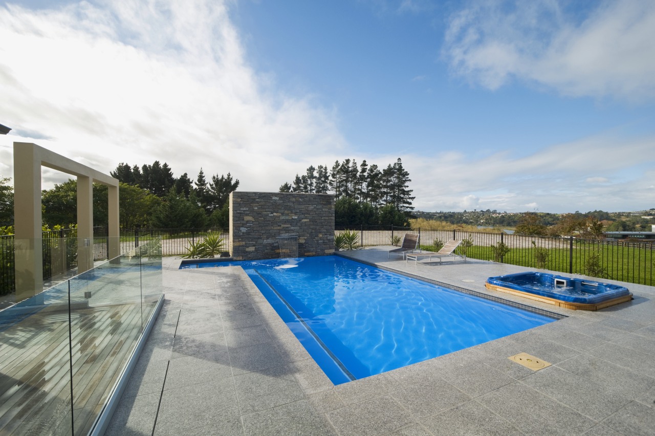 This new L-shaped pool, designed and built by estate, home, house, leisure, property, real estate, residential area, sky, swimming pool, villa, water, gray, teal