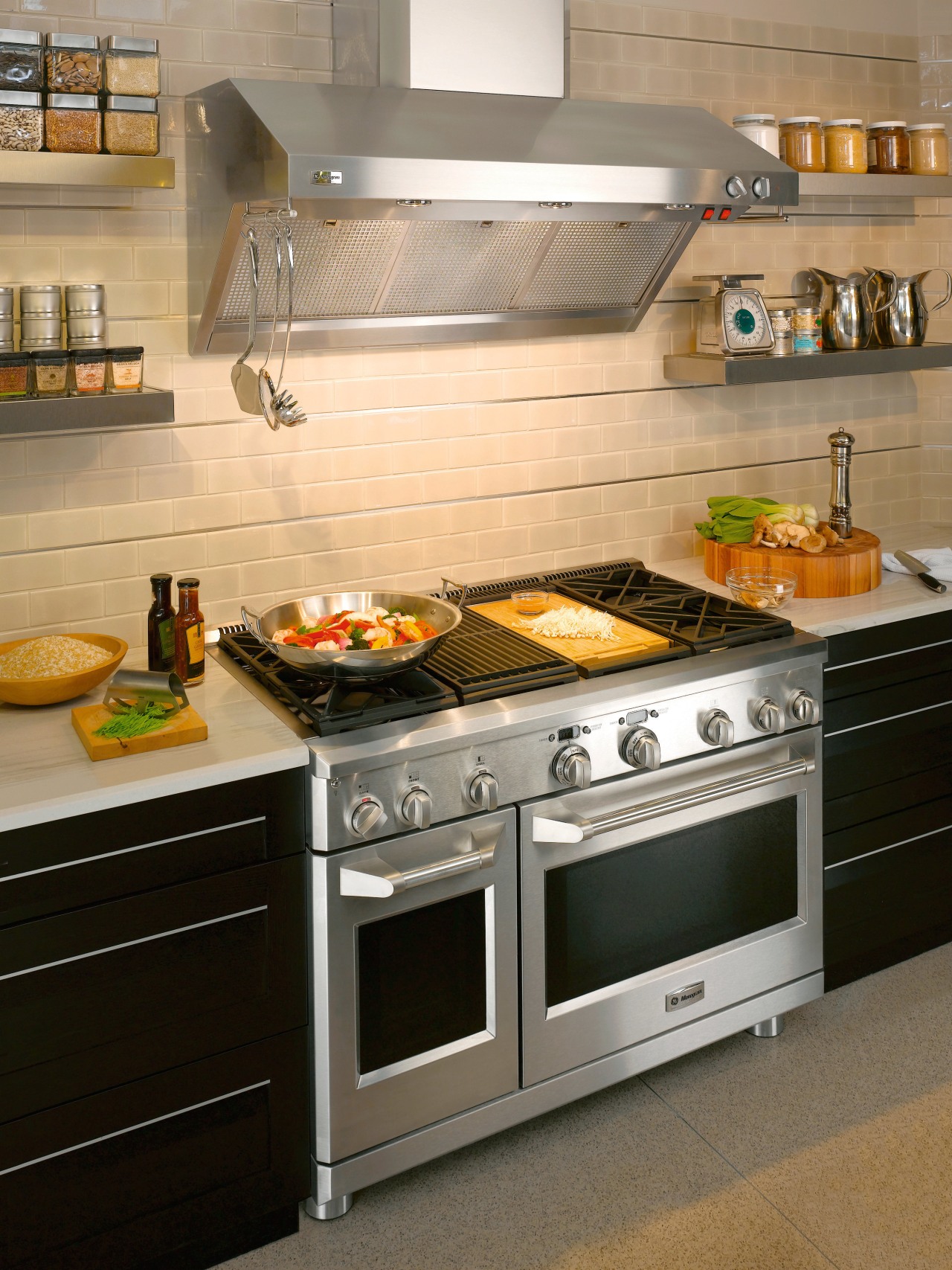 View of a kitchen which features a range, countertop, gas stove, home appliance, kitchen, kitchen appliance, kitchen stove, oven