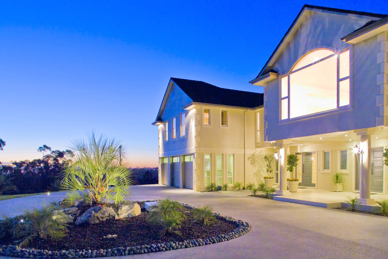 The house has a formal symmetry enhanced by architecture, building, elevation, estate, facade, home, house, mansion, property, real estate, residential area, sky, villa, window, blue