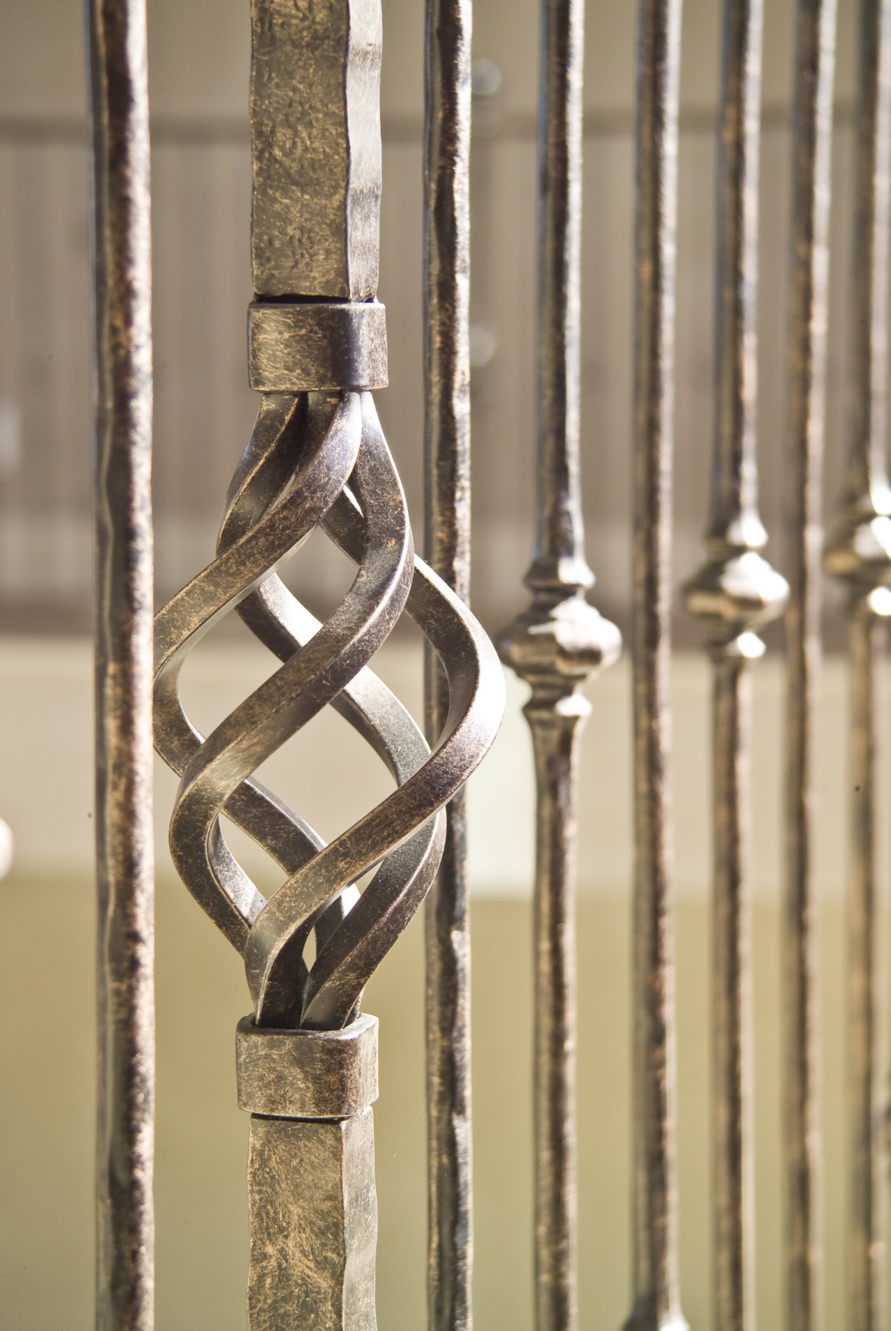 The grand staircase features wrought iron balustrades that brass, iron, metal, brown