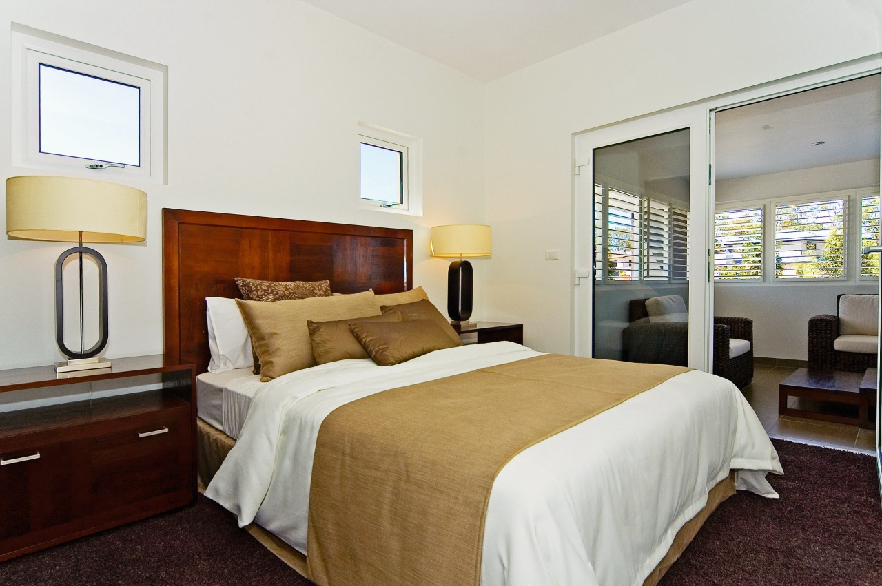 Three of the upper-floor bedrooms open onto a bed frame, bedroom, hotel, real estate, room, suite, white