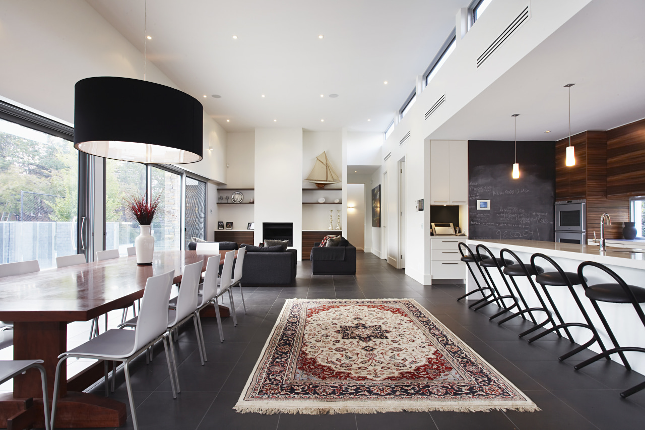 A large open-plan space encapsulates the kitchen and ceiling, interior design, living room, real estate, table, gray