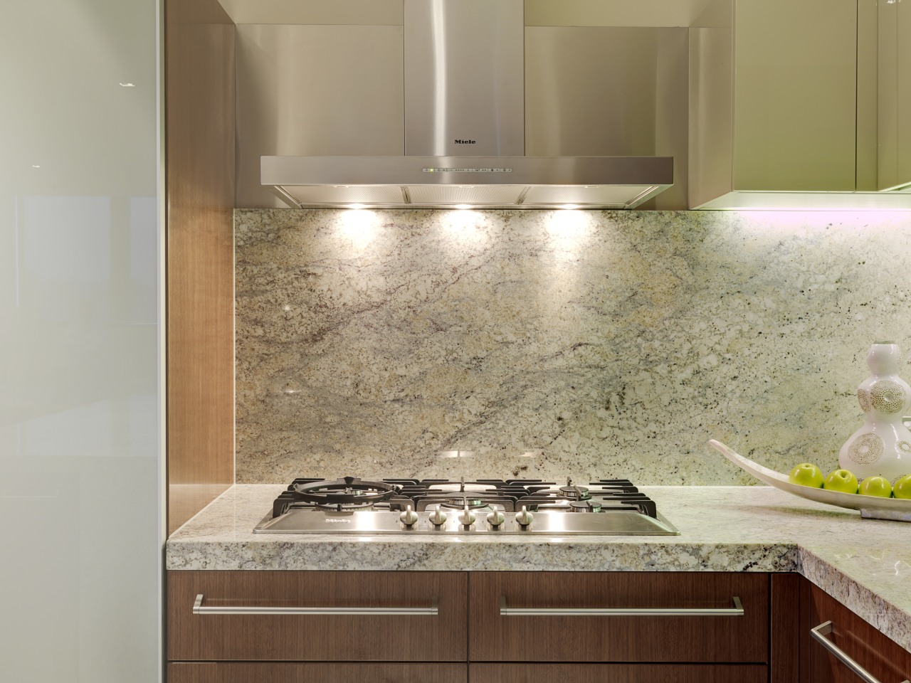 This kitchen in the new Lucient apartments in cabinetry, countertop, flooring, granite, interior design, kitchen, sink, tile, under cabinet lighting, wall, gray, brown