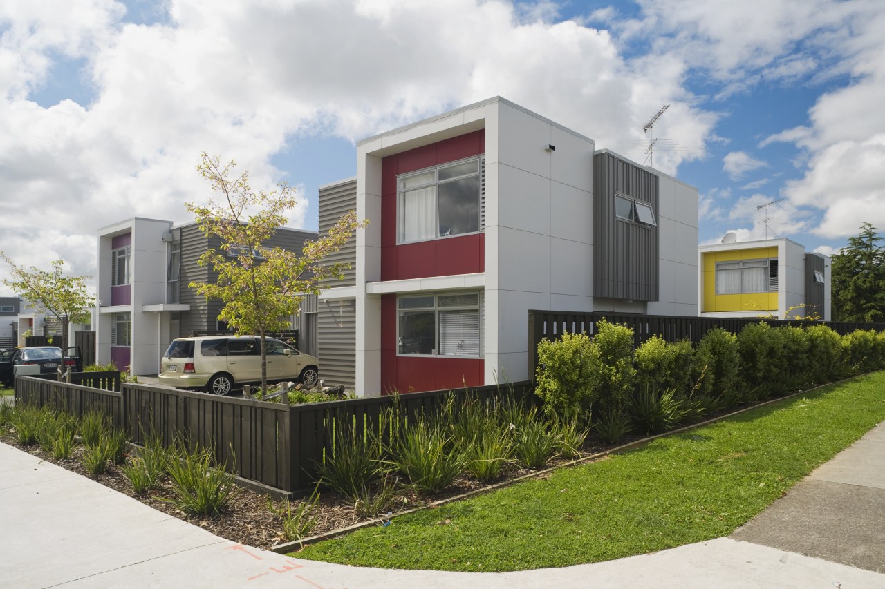 This Housing New Zealand Devlopment features modular homes, architecture, corporate headquarters, elevation, facade, home, house, neighbourhood, property, real estate, residential area, white