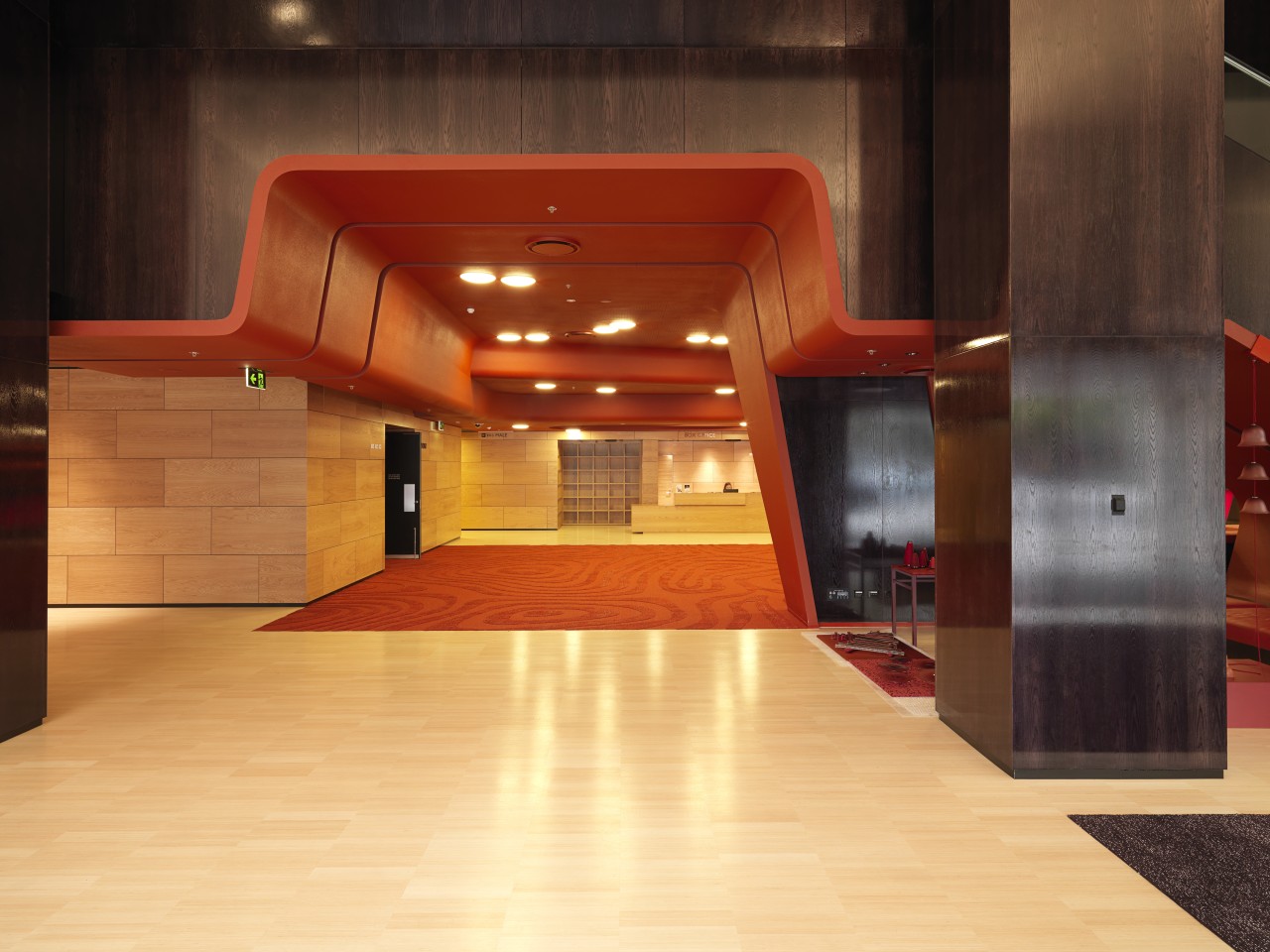 interior view of the MRC which features wood architecture, floor, flooring, interior design, lobby, wood, red, orange