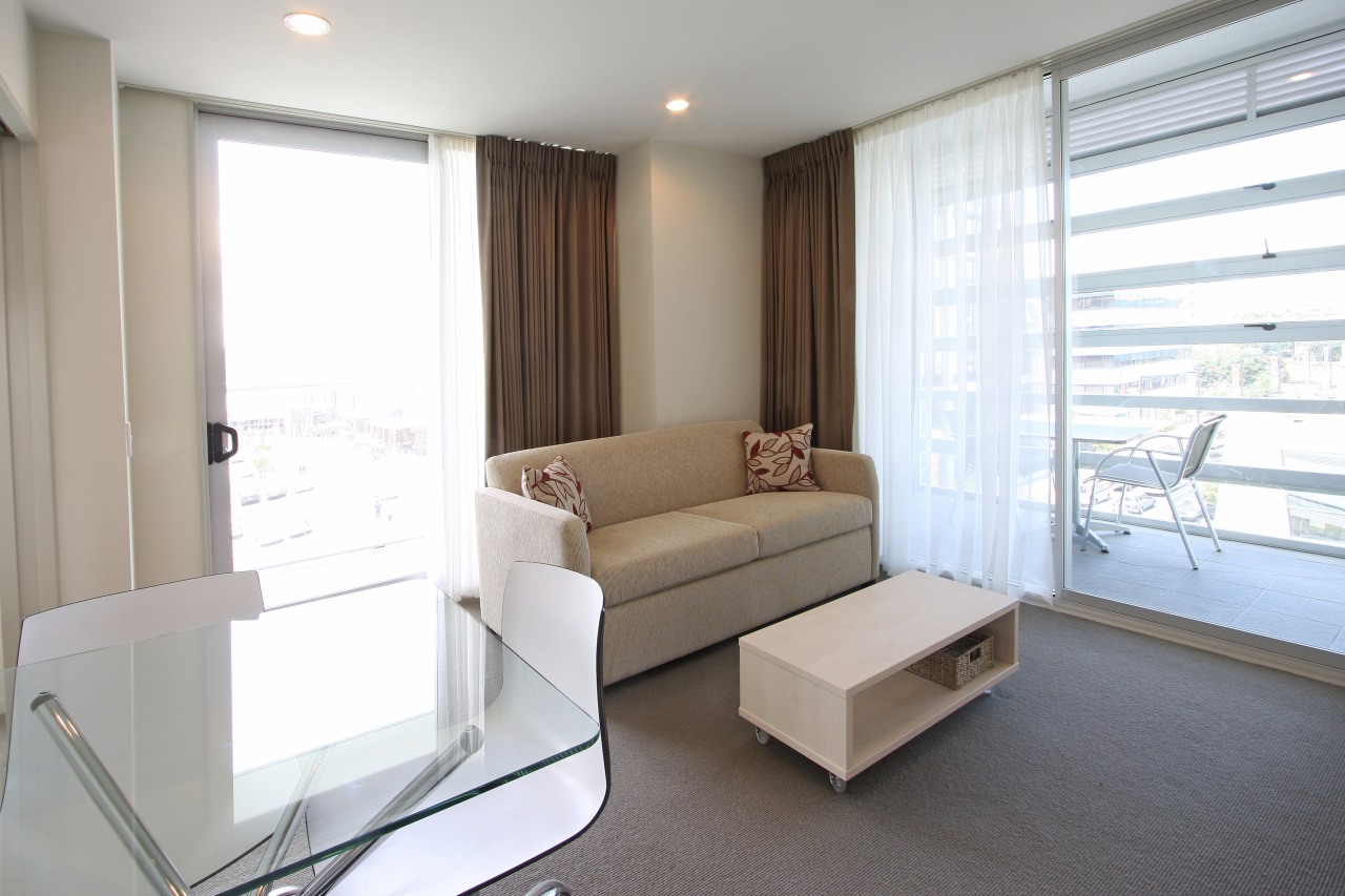 Interior view of the Proximity Apartments constructed by floor, home, interior design, living room, property, real estate, room, window, white, gray