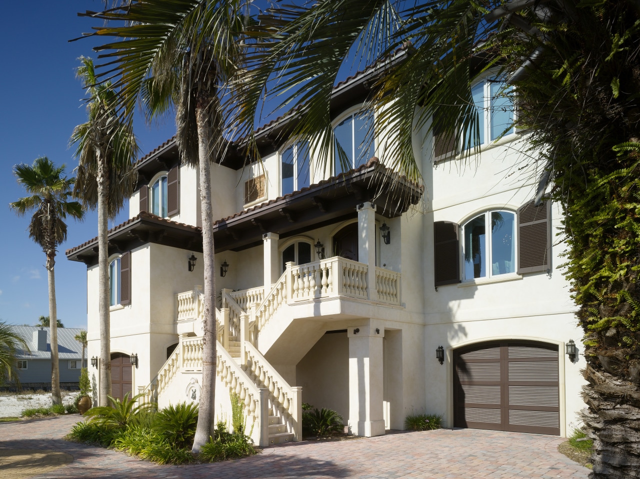 Exterior view of residence which features balconies with apartment, arecales, building, estate, facade, home, house, mansion, palm tree, property, real estate, residential area, villa, black