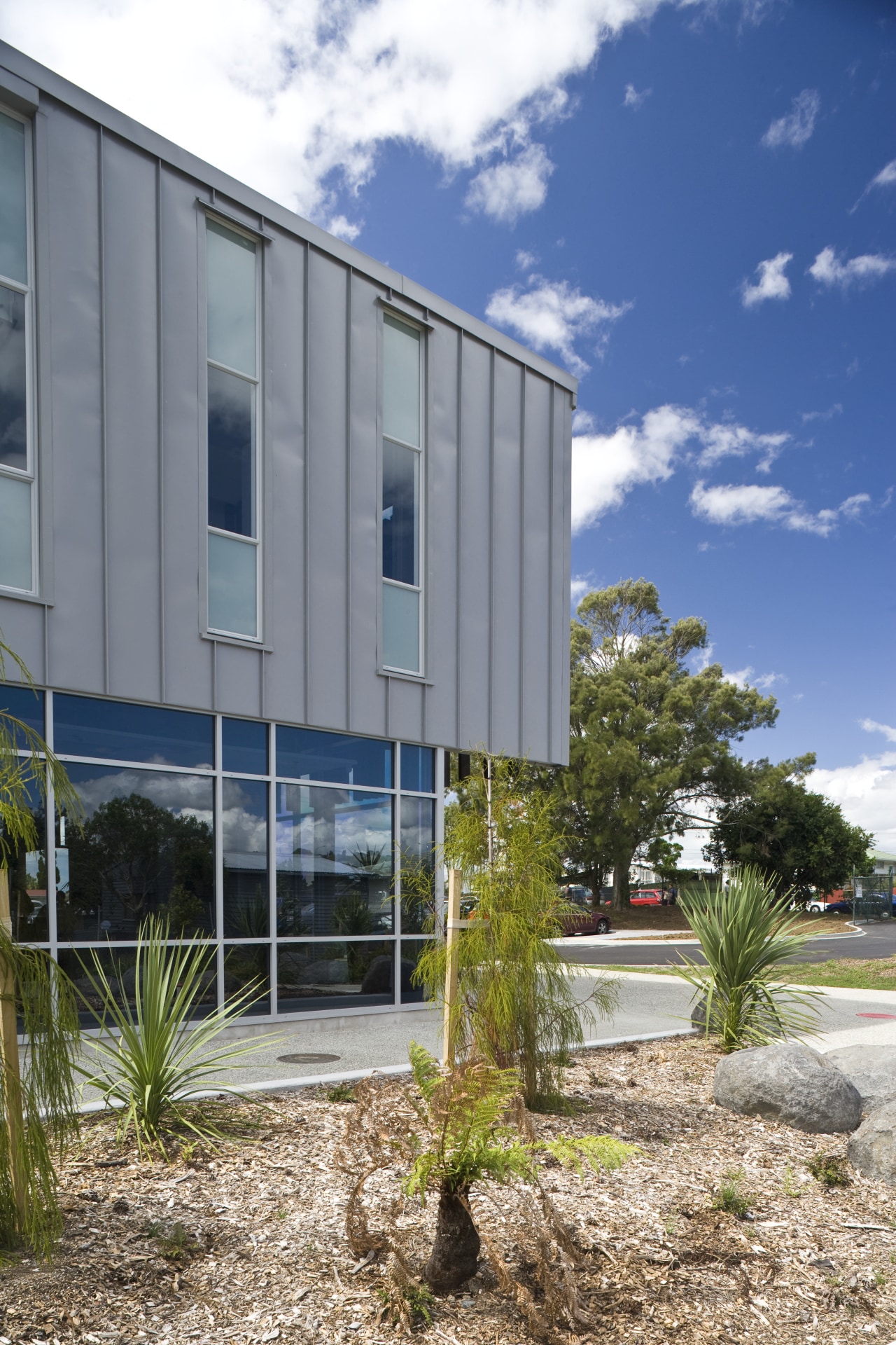 Exterior view of school which features cladding manufactured architecture, building, condominium, corporate headquarters, facade, home, house, property, real estate, sky, window, gray