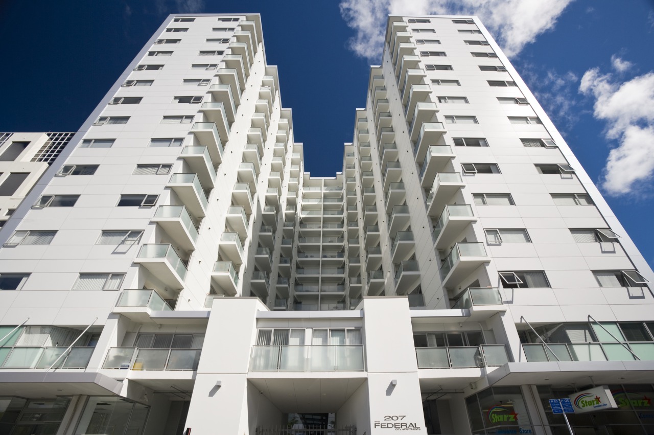 Exterior view of the Federal Apartments where Scarbro apartment, architecture, brutalist architecture, building, commercial building, condominium, corporate headquarters, daytime, elevation, facade, headquarters, hotel, metropolis, metropolitan area, mixed use, property, real estate, residential area, sky, skyscraper, tower block, white, gray