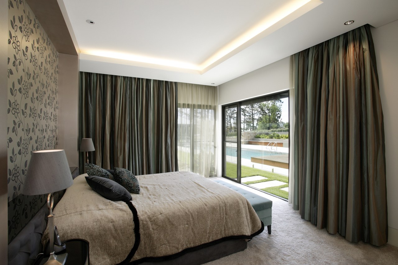 View of the master bedroom which features a bedroom, ceiling, curtain, estate, interior design, property, real estate, room, suite, textile, wall, window, window covering, window treatment, black, white