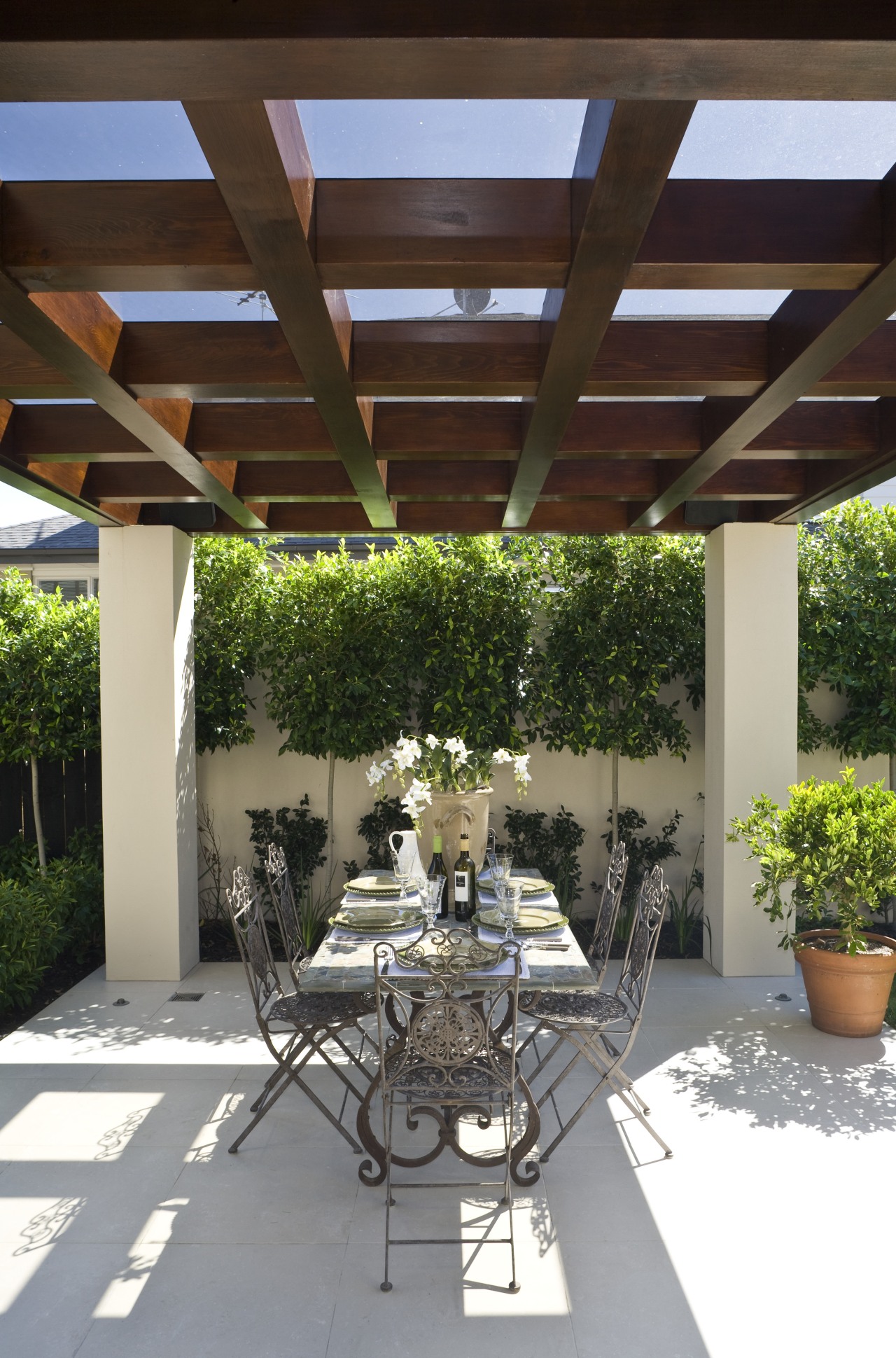 View of the patio area in the Mediterranean-style backyard, courtyard, outdoor structure, patio, pergola, real estate, roof, yard, brown