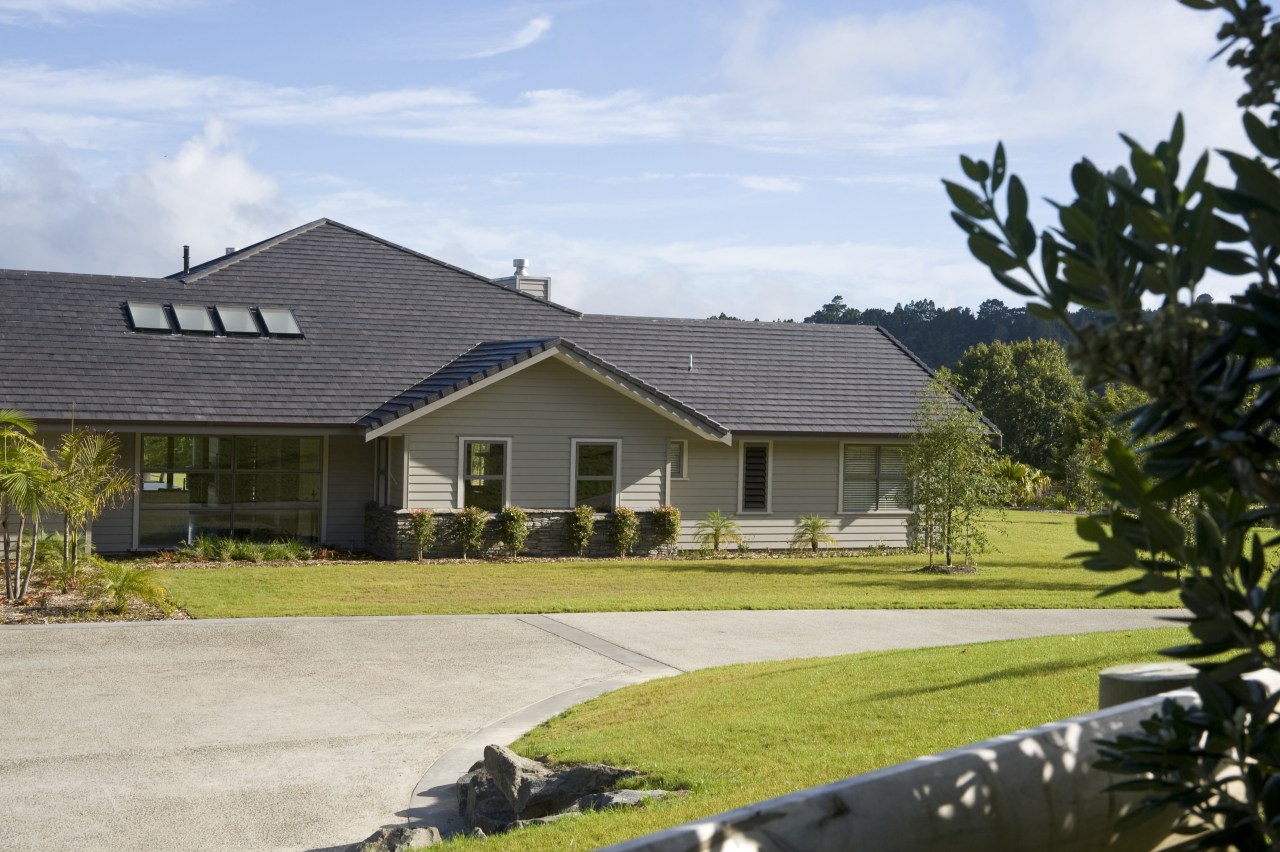 Image of this new home which features Artisan cottage, estate, facade, farmhouse, grass, home, house, land lot, landscape, property, real estate, residential area, roof, siding, suburb, tree, gray