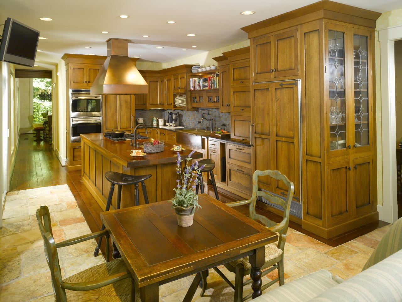 View of a kitchen with casual dining area cabinetry, countertop, cuisine classique, dining room, flooring, furniture, hardwood, home, interior design, kitchen, living room, real estate, room, brown, orange