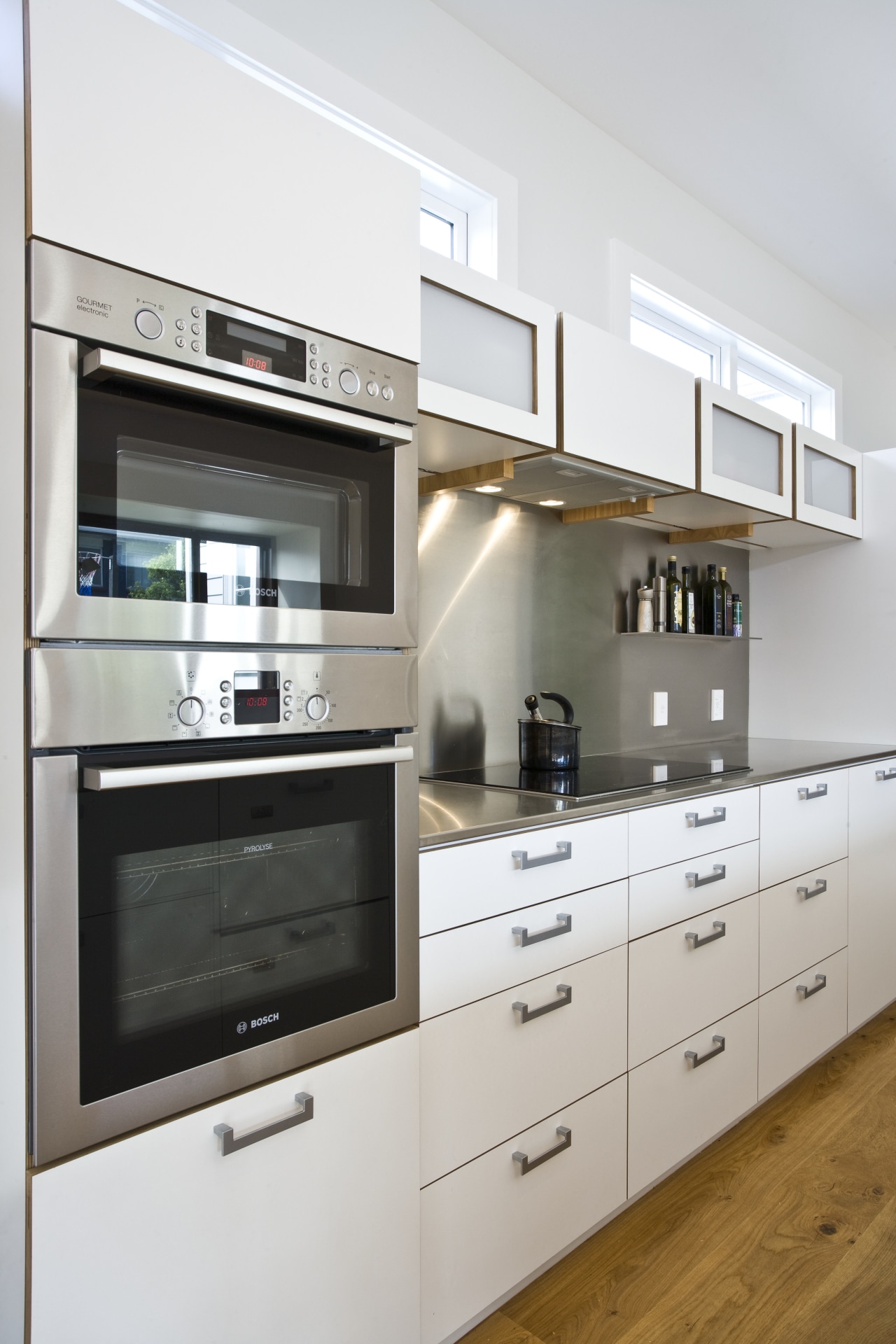 View of kitchen which features white cabinetry with cabinetry, countertop, cuisine classique, home appliance, interior design, kitchen, kitchen appliance, gray, white