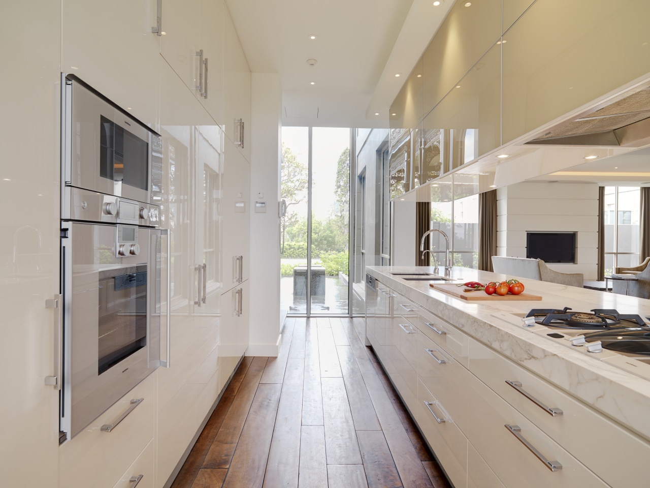 View of large marble island with cooktop, sinks cabinetry, countertop, cuisine classique, floor, interior design, kitchen, real estate, gray
