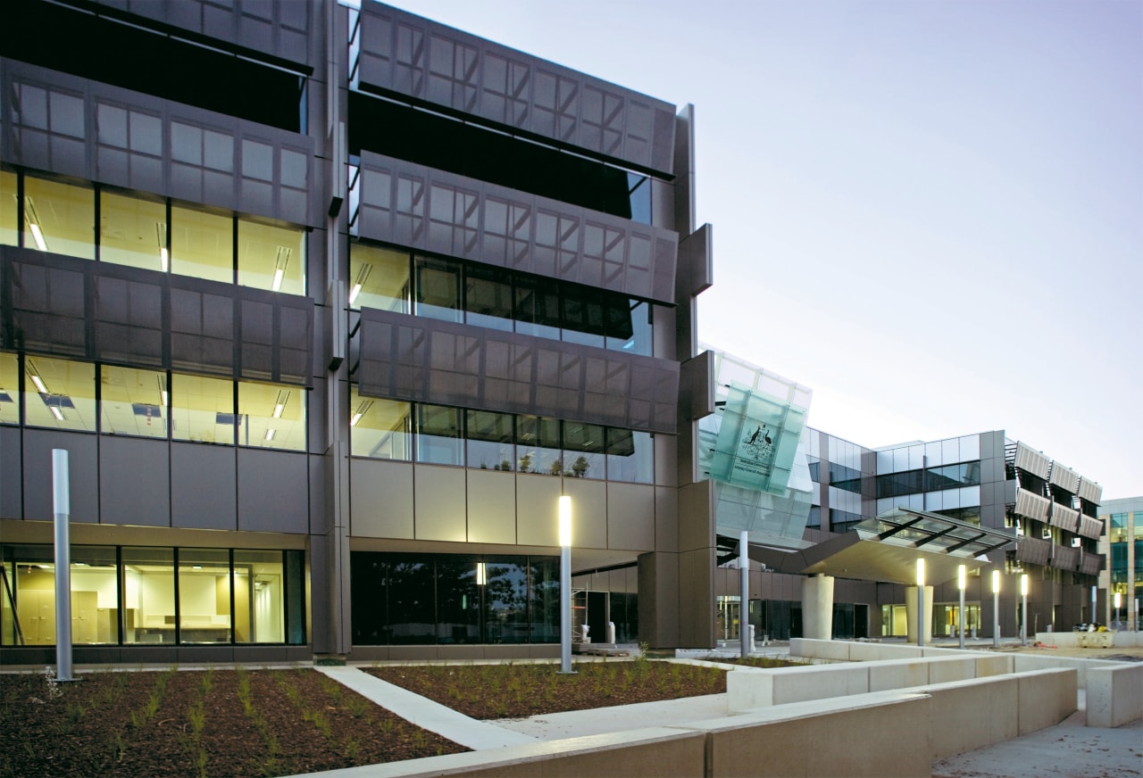 Exterior view of a building which features energy-efficient apartment, architecture, building, commercial building, condominium, corporate headquarters, facade, headquarters, metropolitan area, mixed use, real estate, residential area, white