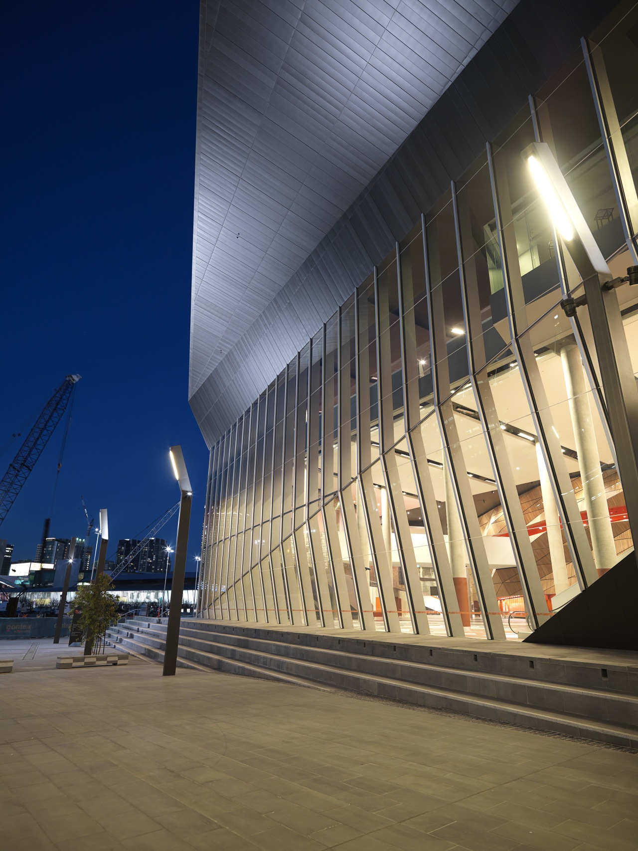 Exterior view of the MCC which features zinc architecture, building, daylighting, facade, fixed link, landmark, lighting, line, metropolitan area, reflection, sky, structure, urban area