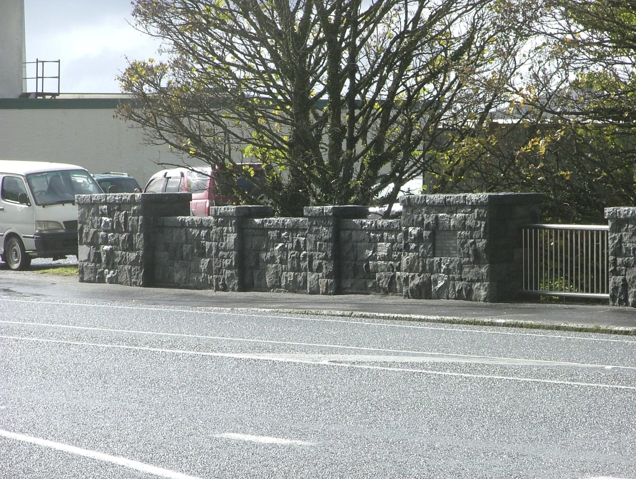 View of the stone balustrade of the Victoria asphalt, automotive exterior, car, fence, luxury vehicle, motor vehicle, plant, road, tree, vehicle, wall, white, gray