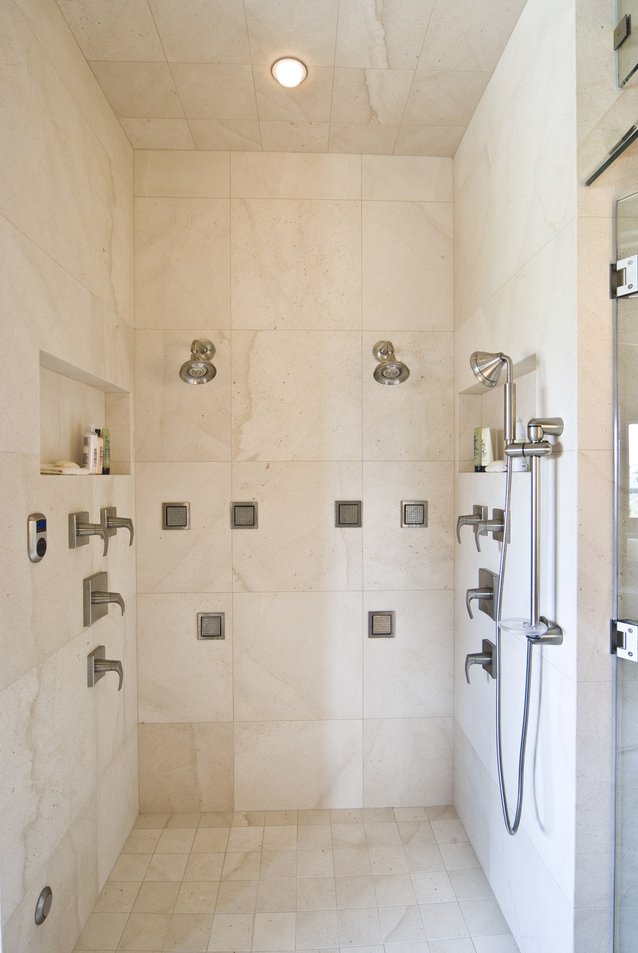 View of shower enclosure which features a variety bathroom, floor, flooring, interior design, plumbing fixture, room, shower, tap, tile, wall, gray