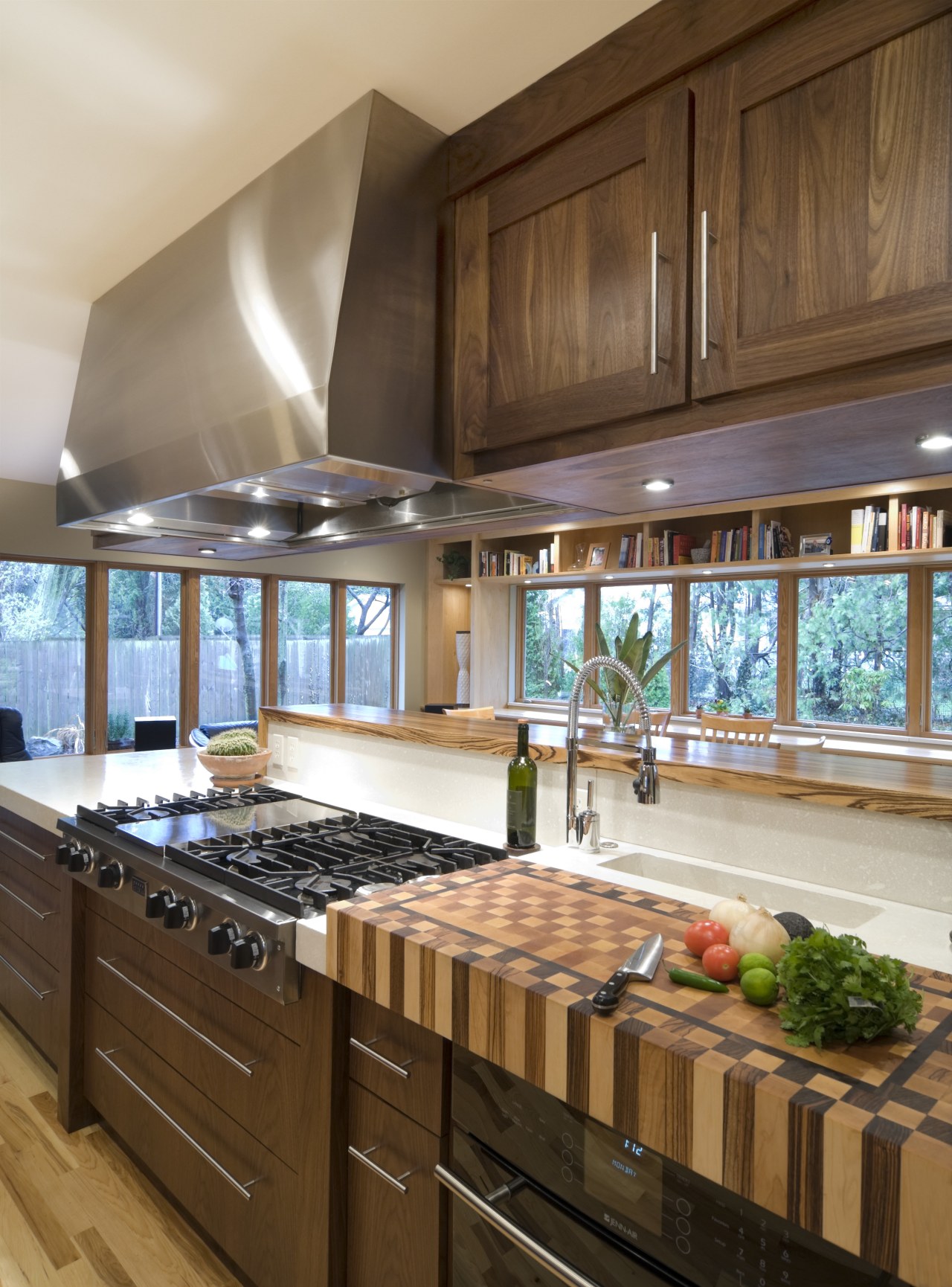 View of a kitchen which features dark-stained overhead cabinetry, ceiling, countertop, cuisine classique, interior design, kitchen, room, under cabinet lighting, brown