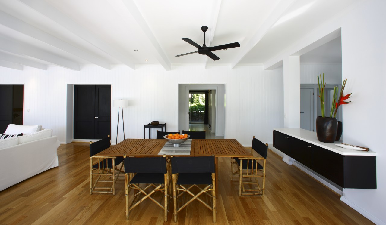 View of the main living area which features ceiling, dining room, floor, flooring, interior design, living room, property, real estate, room, table, wood flooring, white