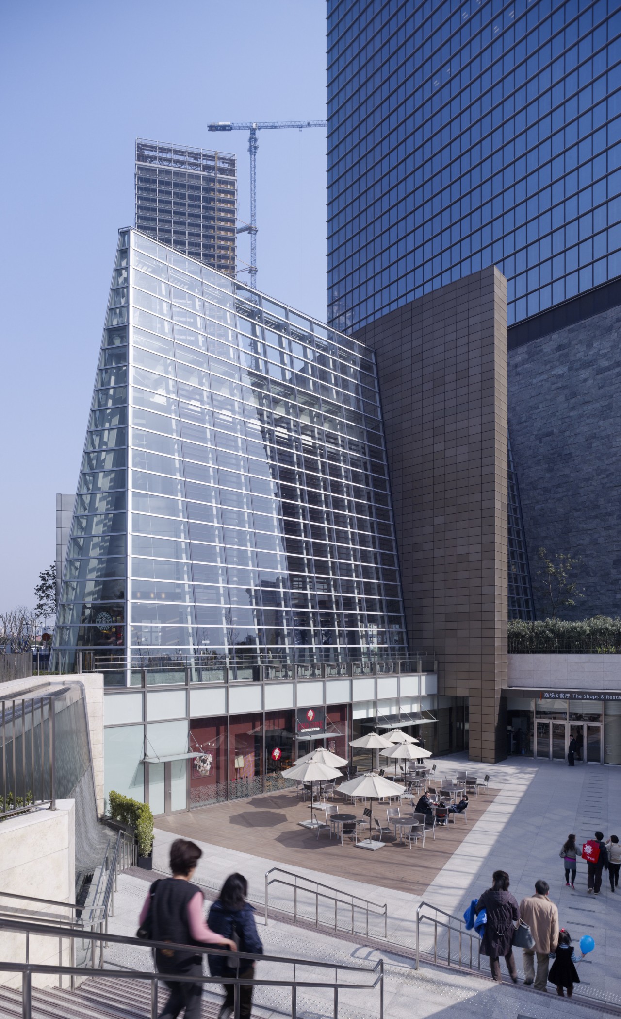 Exterior view of the front entrance which features architecture, building, city, commercial building, corporate headquarters, daytime, facade, headquarters, metropolis, metropolitan area, mixed use, plaza, sky, skyscraper, tower block, gray, blue