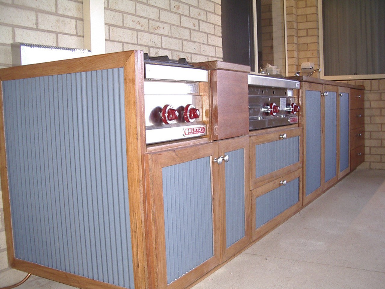 View of an outdoor area which features outdoor furniture, product, wood, gray