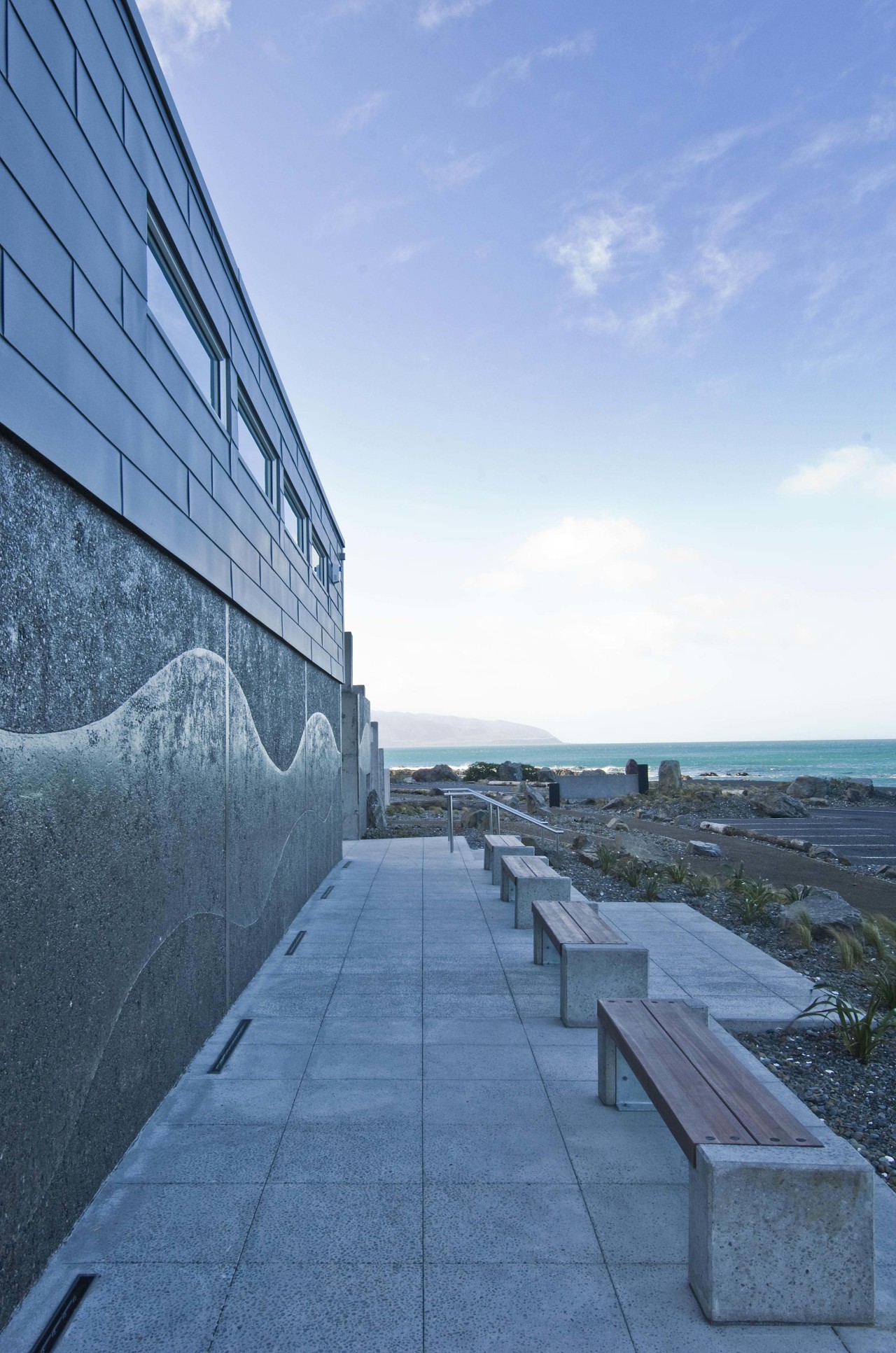 Exterior view of Te Kopahou Reserve Interpretation Centre architecture, building, cloud, daytime, fixed link, horizon, landmark, reflection, roof, sea, sky, structure, water, teal