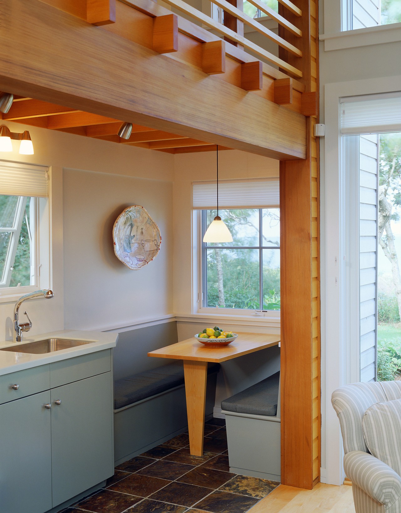 View of a small kitchen area adjacent to architecture, cabinetry, ceiling, countertop, daylighting, home, house, interior design, kitchen, real estate, room, table, window, wood, gray, brown