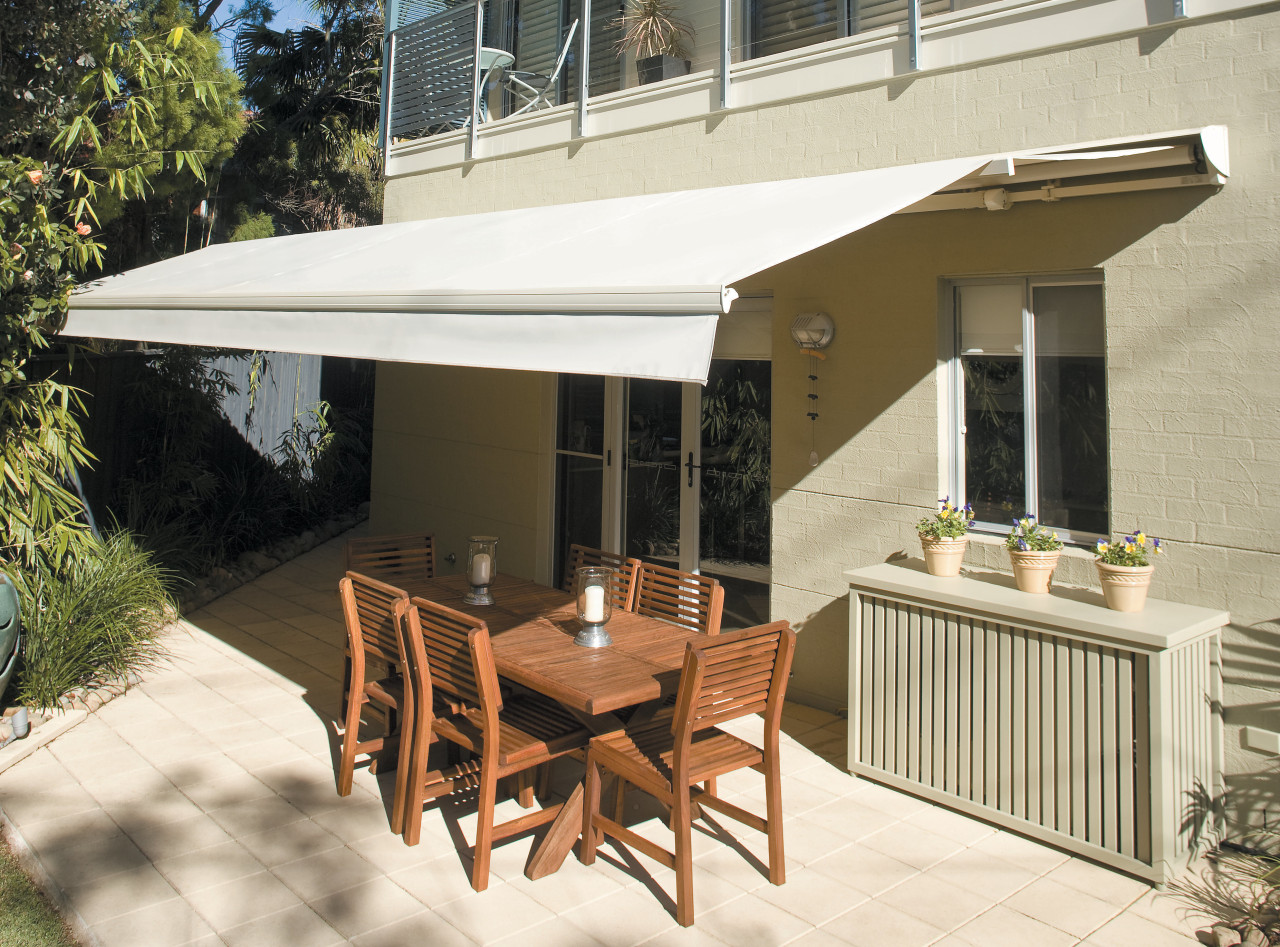 View of an outdoor area which features a awning, canopy, patio, real estate, shade, table, white, brown