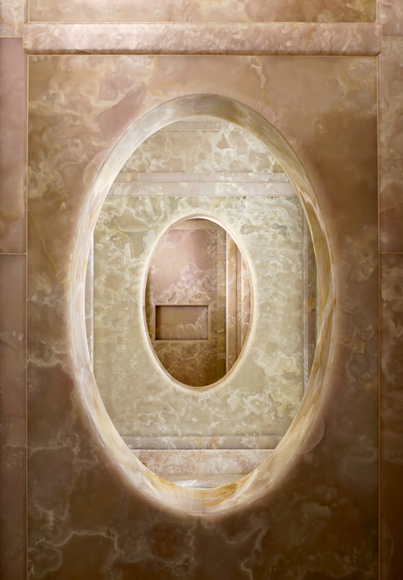 View of the pink onyx panels which feature circle, texture, orange, brown