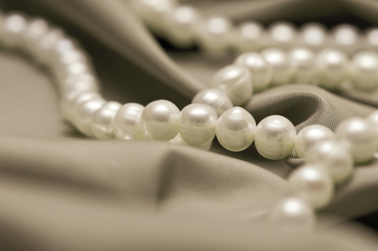 View of a pearl necklace close up, fashion accessory, jewellery, macro photography, material, pearl, orange, brown