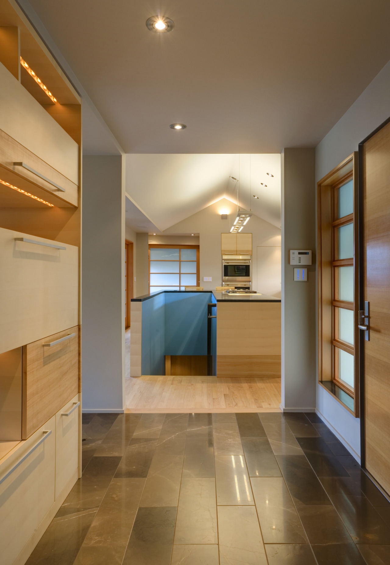 View of a front entrance looking into kitchen architecture, cabinetry, ceiling, countertop, daylighting, floor, flooring, hardwood, home, interior design, kitchen, laminate flooring, lighting, lobby, real estate, room, wood, wood flooring, brown, orange