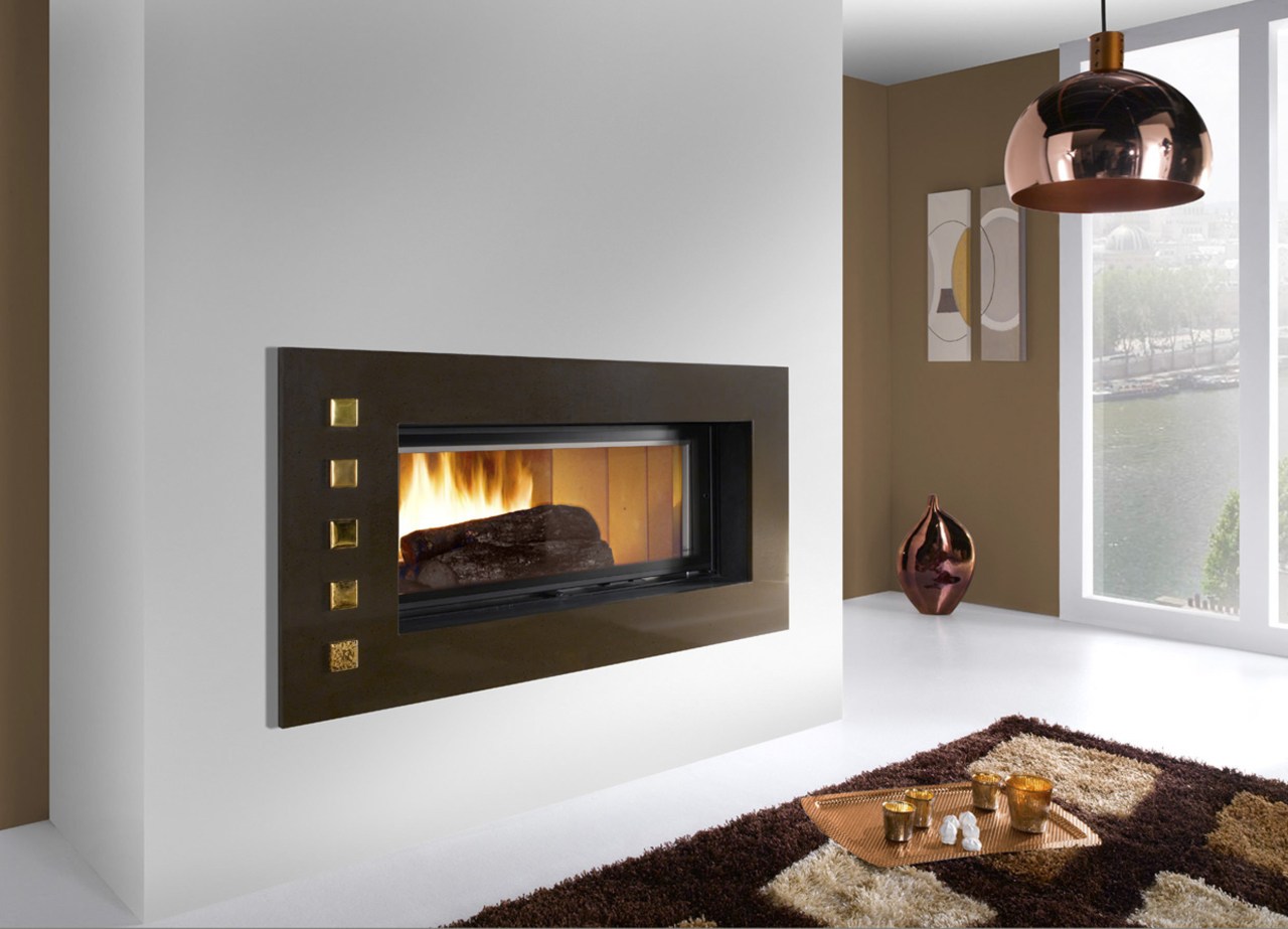 View of a living area which features a fireplace, hearth, heat, home appliance, wood burning stove, gray