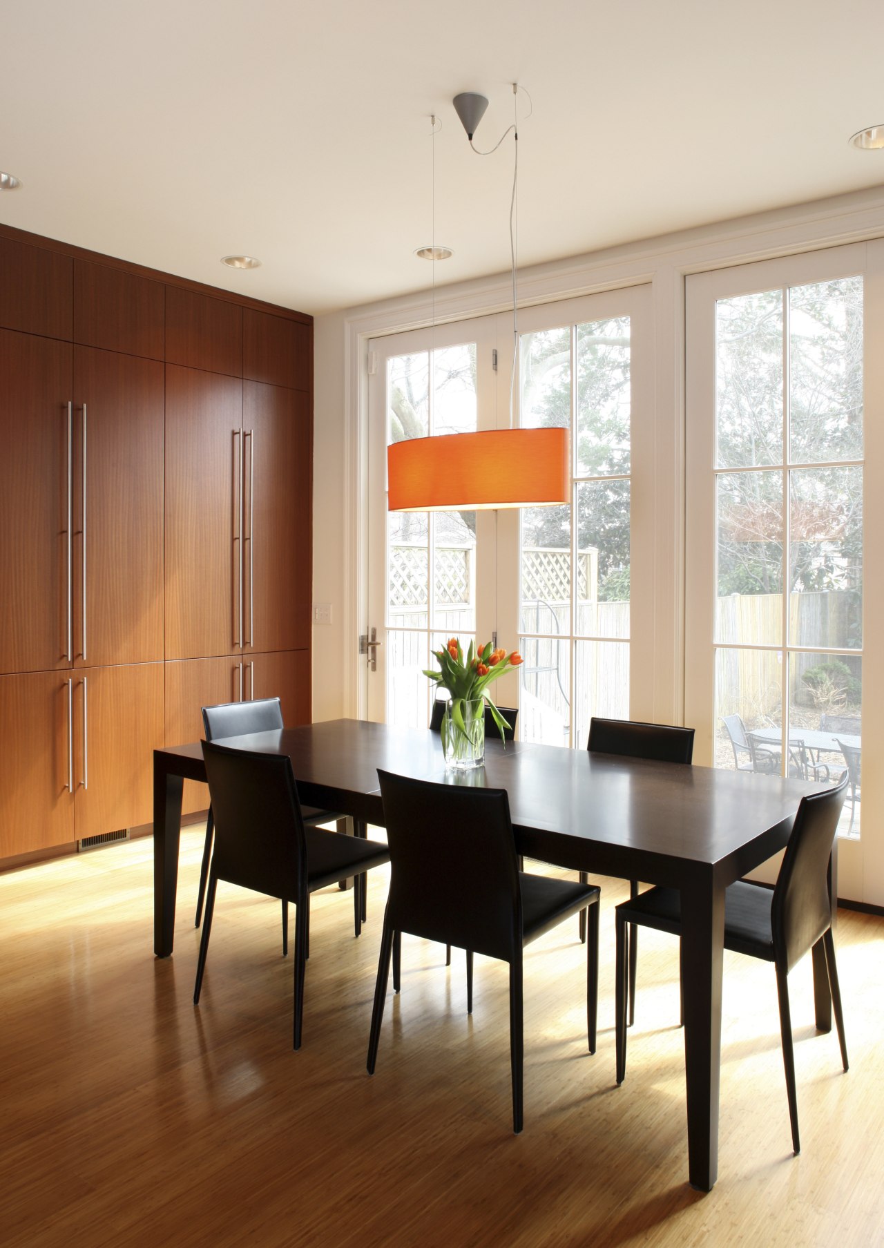 View of the open-plan dining area adjacent to ceiling, chair, dining room, floor, flooring, furniture, hardwood, interior design, living room, room, table, window, window covering, wood, wood flooring, white