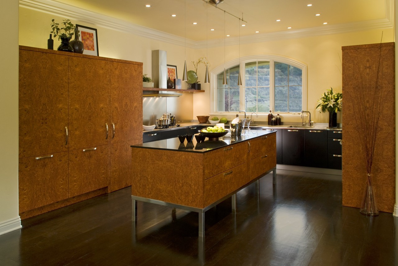 The owners of this kitchen, designed by the cabinetry, countertop, cuisine classique, floor, flooring, hardwood, interior design, kitchen, laminate flooring, living room, real estate, room, wood, wood flooring, brown, orange