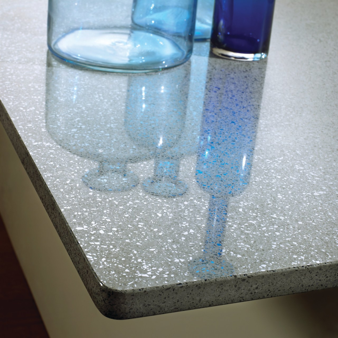 View of a contemporary kitchen which features countertops drinkware, glass, tap, water, gray