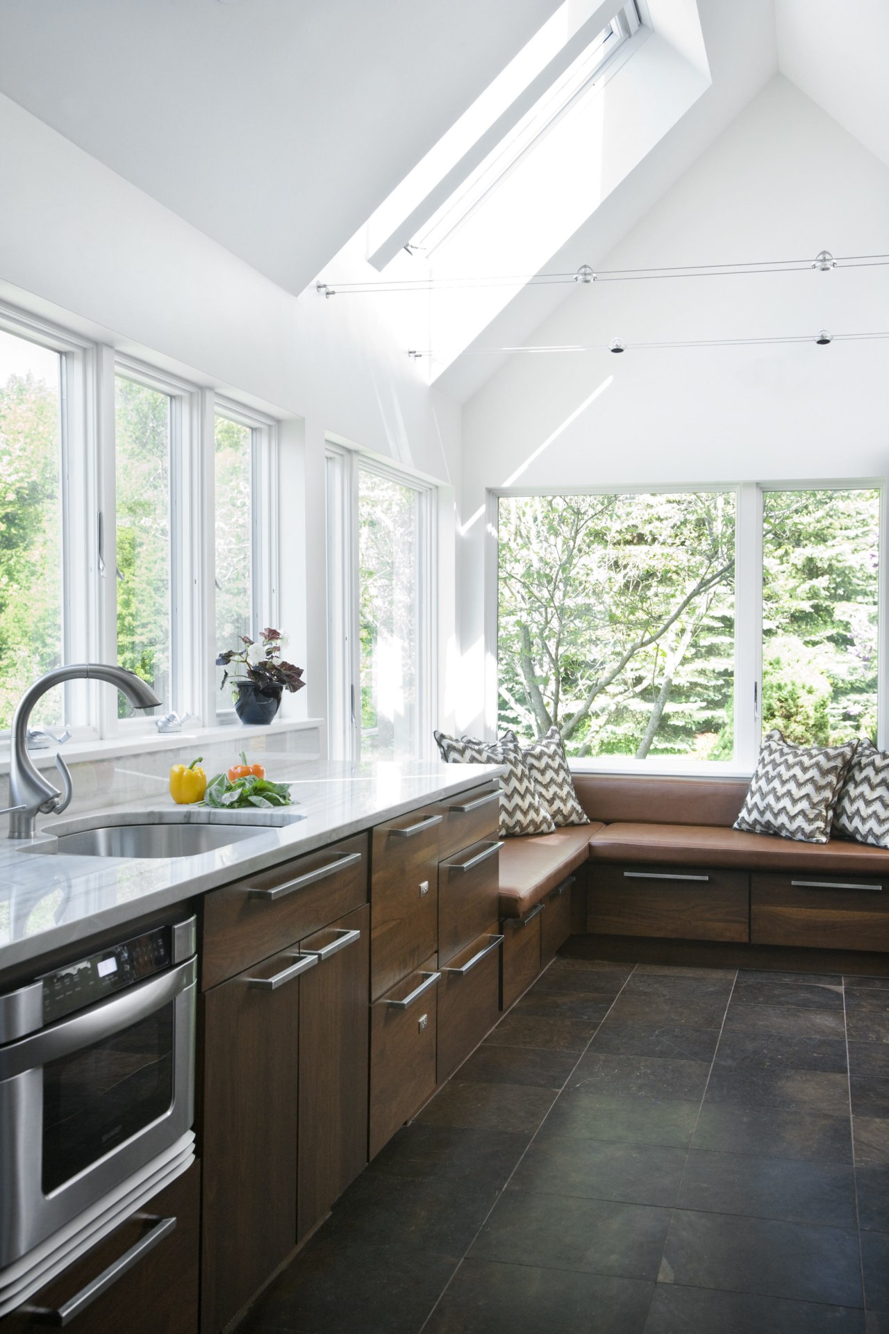 View of a kitchen which features white quartzite cabinetry, ceiling, countertop, cuisine classique, daylighting, floor, home, house, interior design, kitchen, real estate, room, window, white