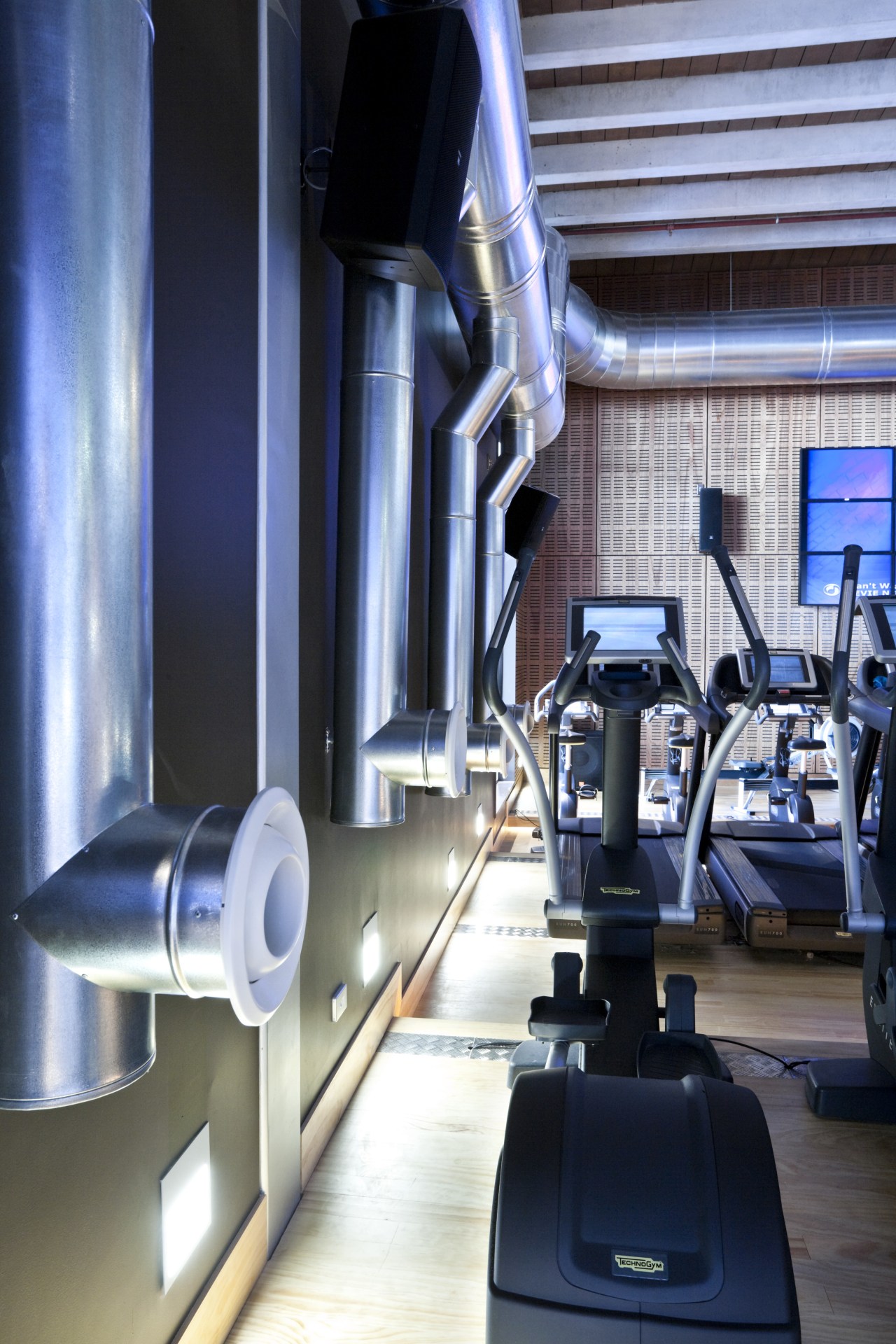 The Les Mills gymnasium features the Air-Change air exercise machine, gym, room, sport venue, structure, blue