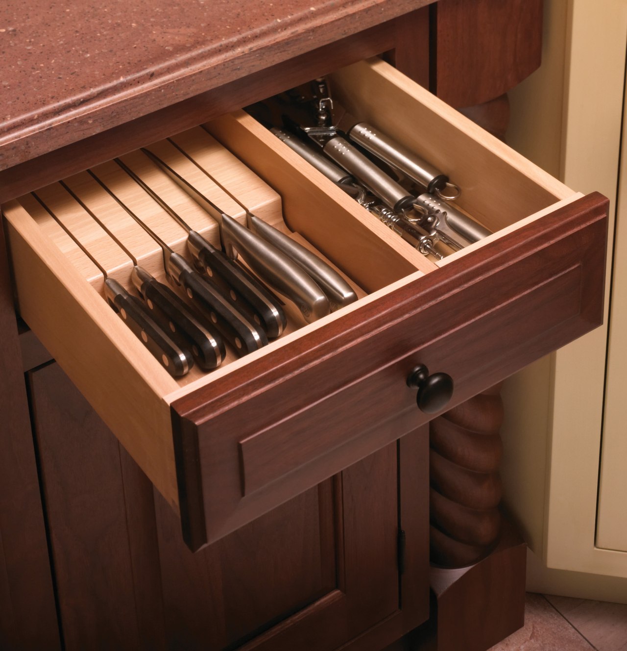 This kitchen features compartmentalized storage solutions.This kitchen features drawer, furniture, wood stain, brown