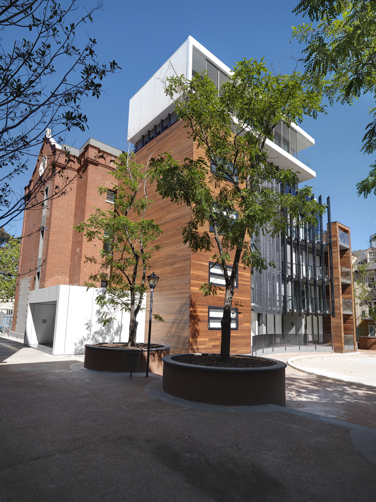 View of the Rathdowne building with its refurbished architecture, building, campus, condominium, daytime, facade, mixed use, neighbourhood, plant, real estate, residential area, tree, black