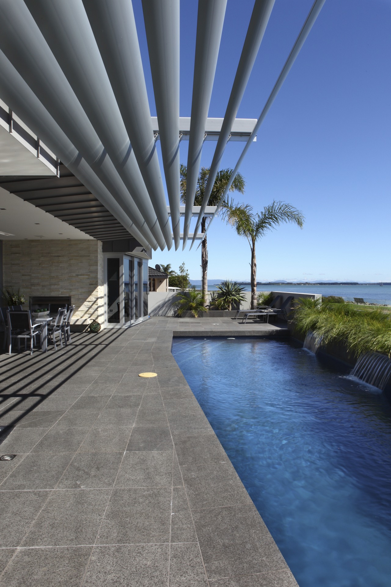 View of Pool resource pools architecture, condominium, estate, house, property, real estate, resort, sky, swimming pool, walkway, water, gray, blue