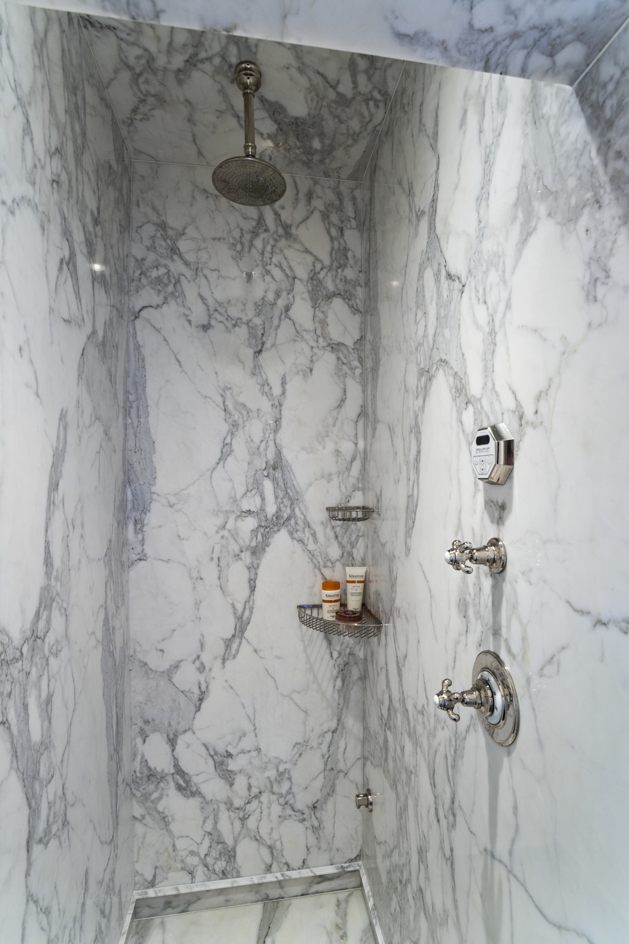 View of the master bathroom which features a plumbing fixture, wall, gray