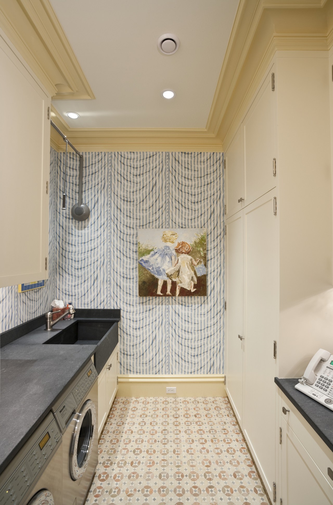 Interior view of this laundry area which features ceiling, countertop, floor, flooring, home, interior design, kitchen, laundry room, property, real estate, room, tile, wall, gray