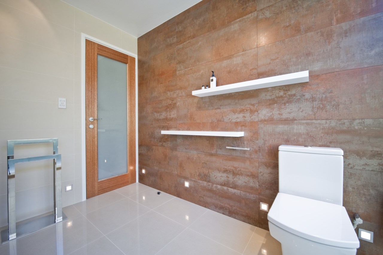 View of home theater powder room designed by architecture, bathroom, daylighting, floor, flooring, home, house, interior design, laminate flooring, plaster, property, real estate, room, tile, wall, gray