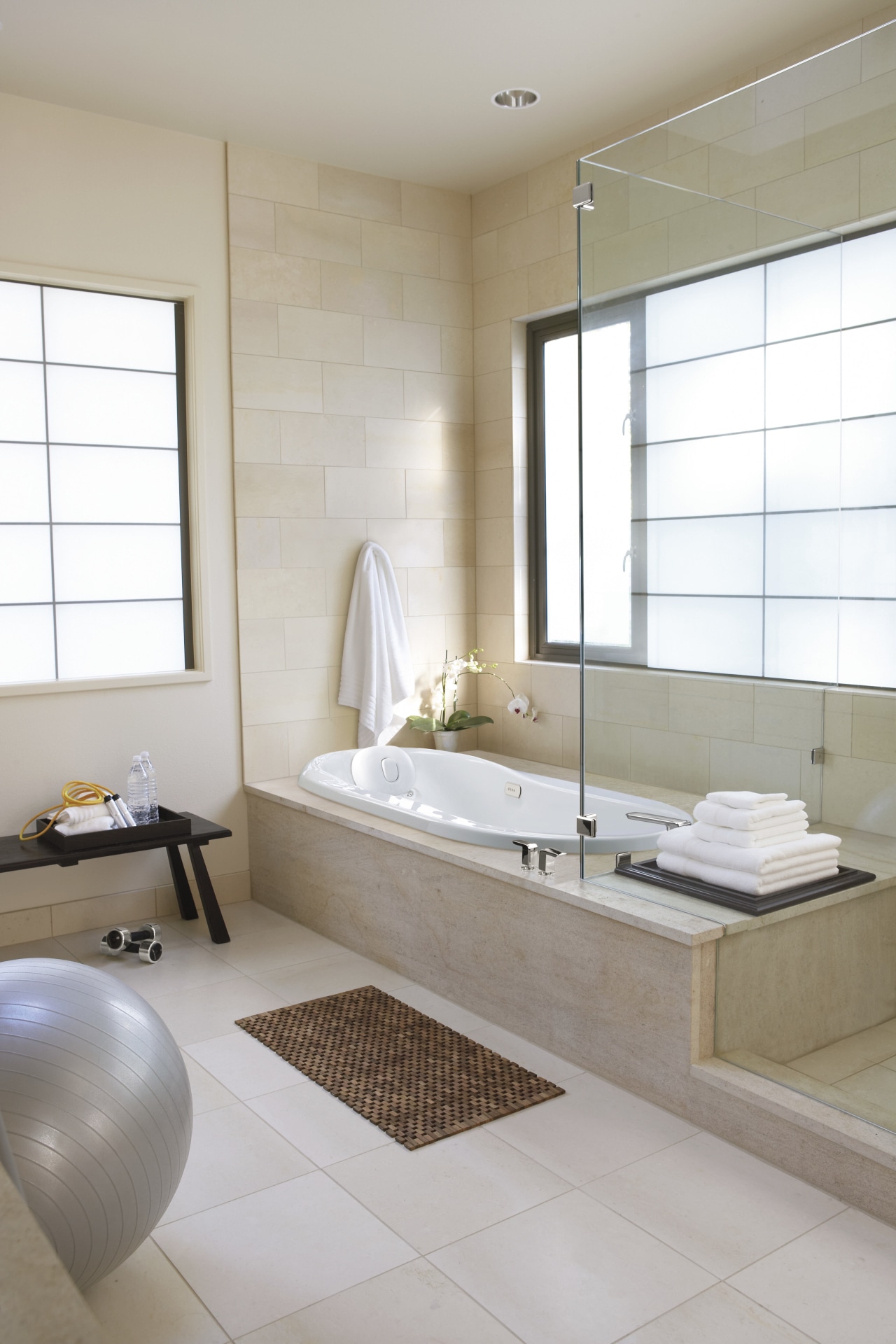 View of a bathroom which features a high-end bathroom, floor, flooring, interior design, plumbing fixture, room, sink, tile, wall, window, wood flooring, gray